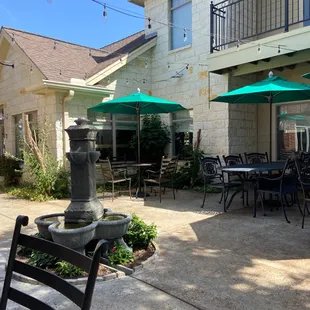 a patio with tables and umbrellas