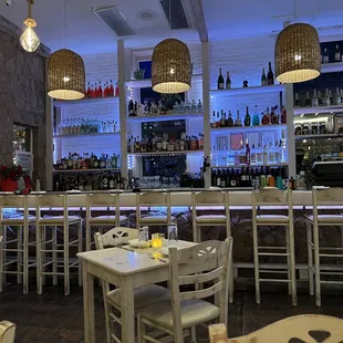 a restaurant with white tables and chairs