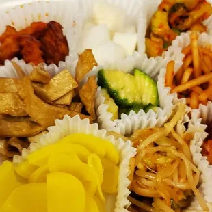 a variety of food items in a styrofoam container
