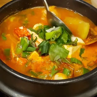a bowl of soup with a spoon in it