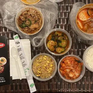 My takeout order: Soft tofu soup (soondubu), spicy pork, rice, and side dishes (banchan) of kimchi, bean sprouts and cucumber kimchi