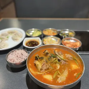 a bowl of soup and bowls of rice