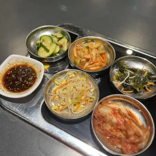 a variety of asian dishes on a tray