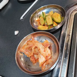 two dishes of kimak and vegetables