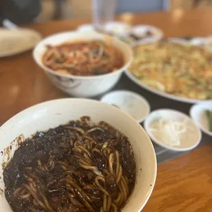 a bowl of noodles and other dishes