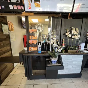 a counter with flowers and menus