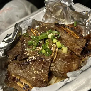 a plate of meat wrapped in foil