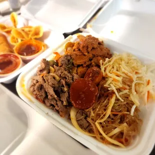 a variety of food in a styrofoam container
