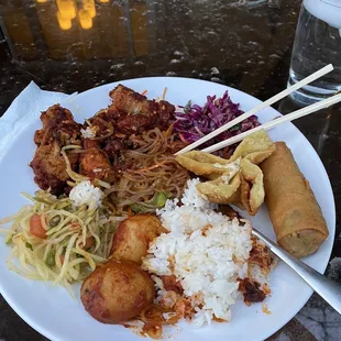 Combo 1 with Catfish, potatoes, noodles, red cabbage salad, papaya salad, crab rangoon, and egg roll