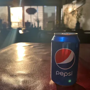 a can of pepsi on a table