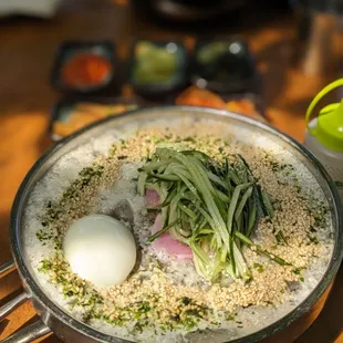 The most aesthetic Naengmyeon with some frothy top and sesame seeds