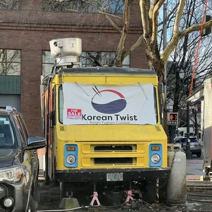 a yellow truck parked in front of a building