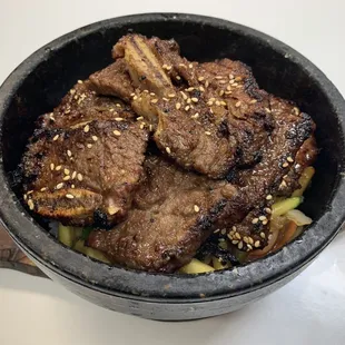 a bowl of food with meat and vegetables