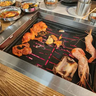 a grill with various types of food on it