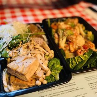 two trays of food on a table
