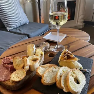 a table with bread, bread, and a glass of wine