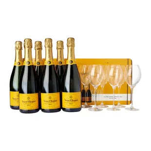 six bottles of champagne and four empty wine glasses