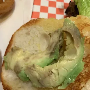 Brown avocado. Top left is part of a cold greasy onion ring.