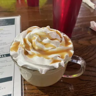 a cup of coffee with whipped cream and caramel