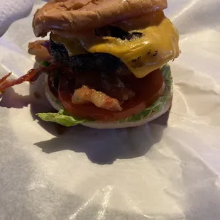 a hamburger with bacon and cheese