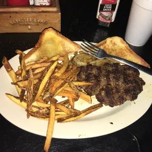 a plate of french fries and steak