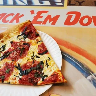 a slice of pizza on a paper plate