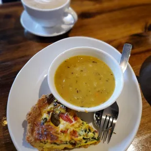 a bowl of soup and a slice of quiche