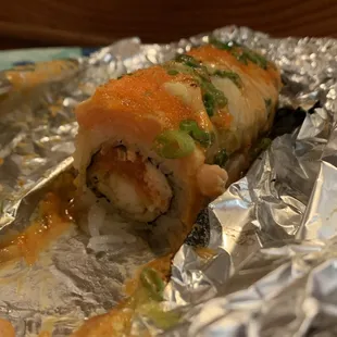 a piece of sushi wrapped in foil
