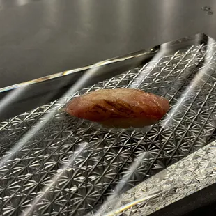 a hot dog on a piece of tin foil