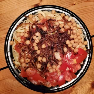 Koshary - spaghetti, macaroni, angel hair pasta, rice, lentils, chickpeas, and fried onions and spicy tomato sauce
