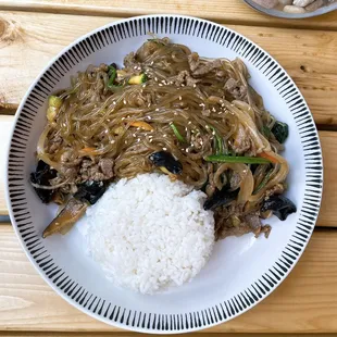 Stir-fried glass noodles with mixed vegetables seasoned with soy sauce and sesame oil. Choice of bulgogi beef or tofu.