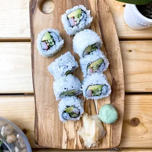 sushi rolls on a wooden cutting board