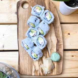 a sushi on a wooden cutting board