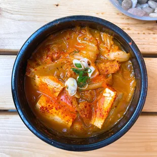 Traditional spicy kimchi stew with pork and tofu.