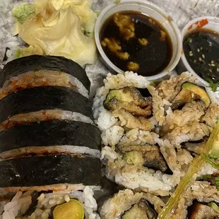 a plate of sushi and vegetables