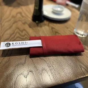 a red napkin on a wooden table