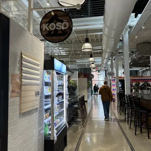 the inside of a restaurant with people walking by
