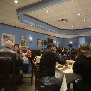 people sitting at tables in a restaurant