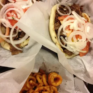 Two gyro sandwiches and side of spicy curly fries