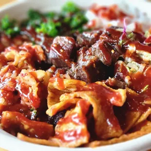 Close up a customized bowl with bulgogi beef and Mexican steak.