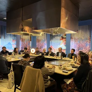 a large group of people sitting at a table