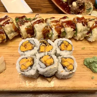 a variety of sushi on a cutting board