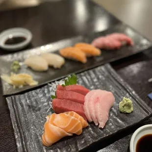 a variety of sushi on a black plate