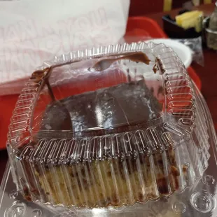  a cake in a plastic container