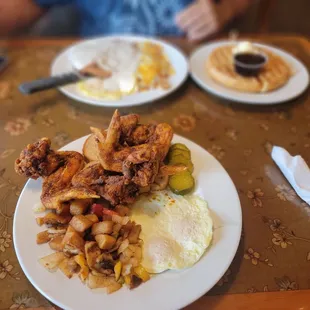 Fried chicken wings breakfast with Nashville sauce and home fries! Omg amazing!  chicken fried steak and waffles chef's kiss!