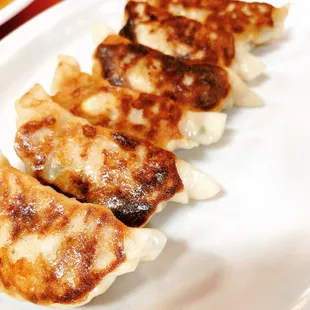 hree dumplings on a white plate