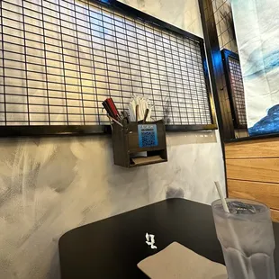 Booth, you get paper straw and silverware is on the wall.