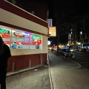 a man walking down the street at night