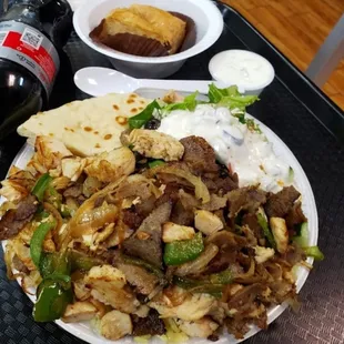 a plate of food and a bottle of beer
