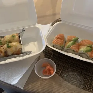 two take out boxes with sushi